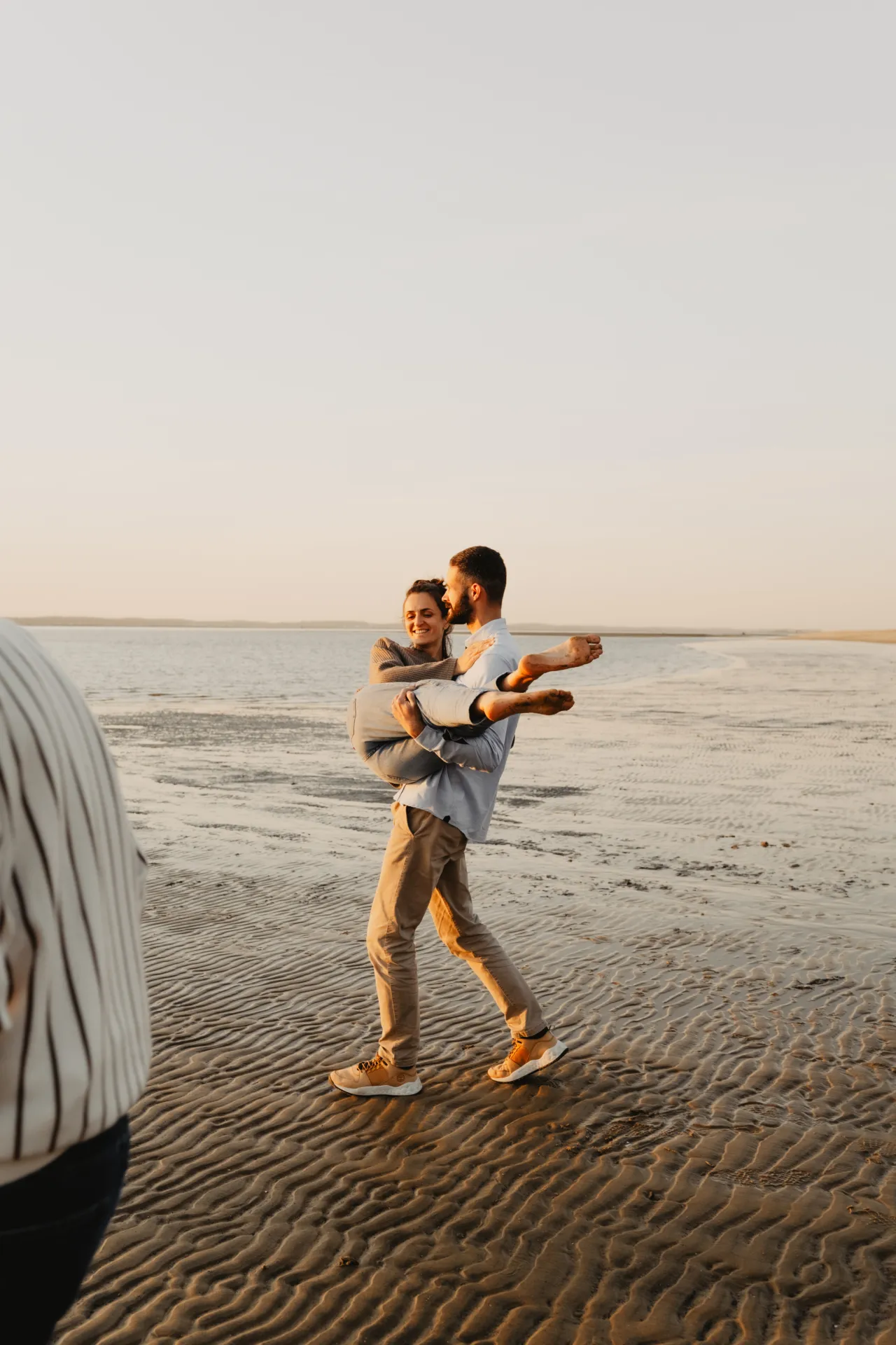 Famille marchant ensemble au coucher du soleil sur la plage