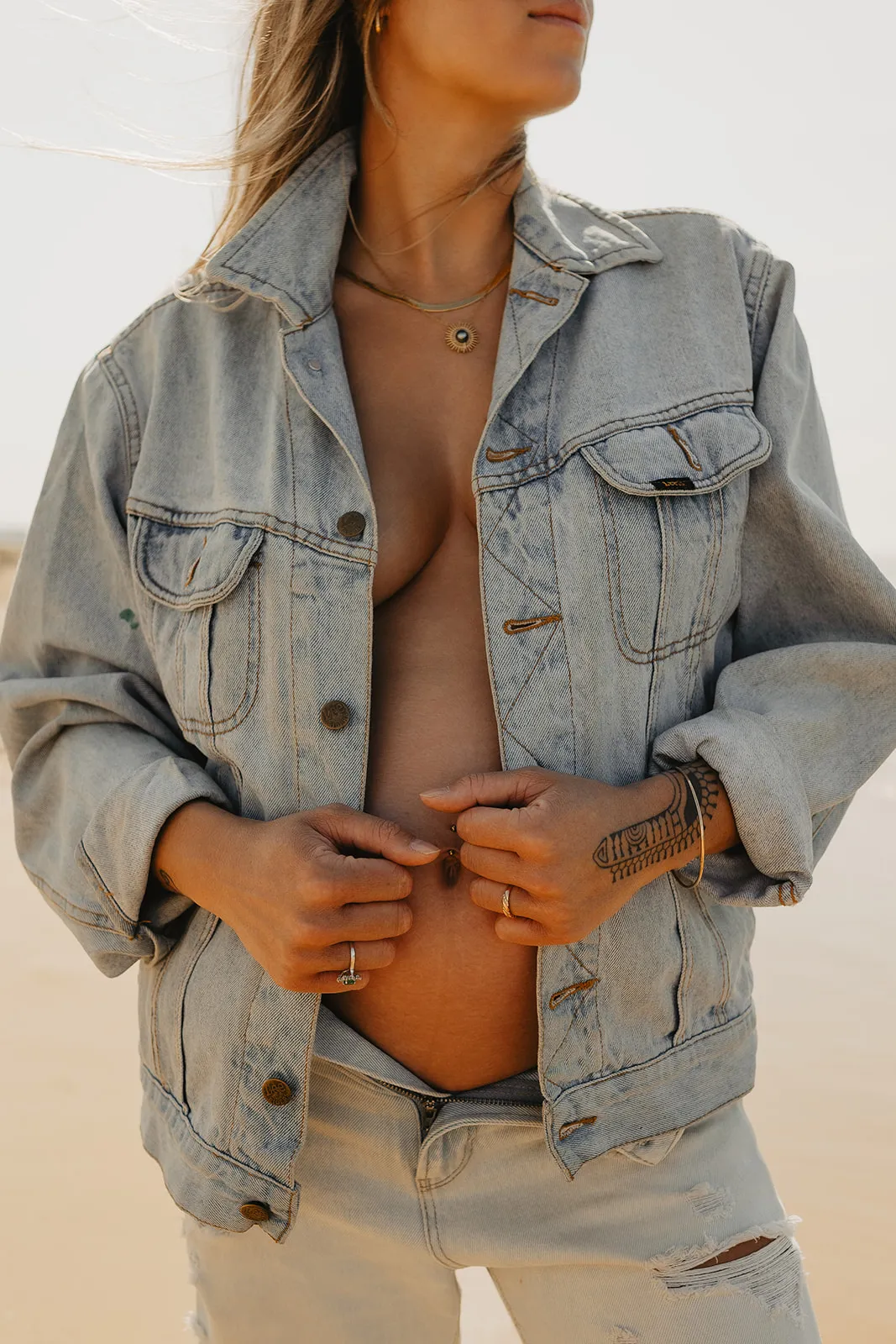 Futur papa posant sa main sur le ventre de maman en forêt