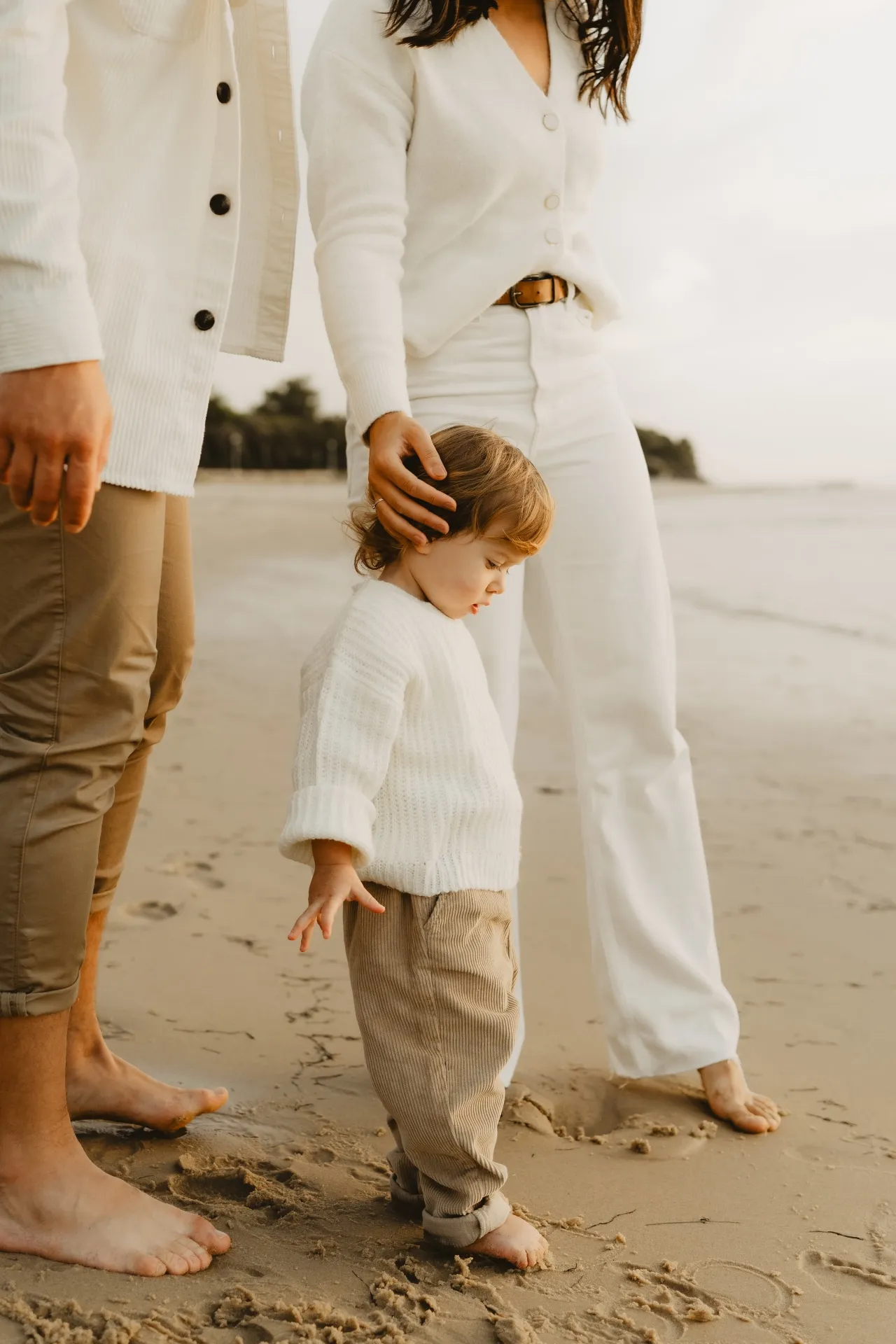 Famille assise dans les dunes en lumière dorée